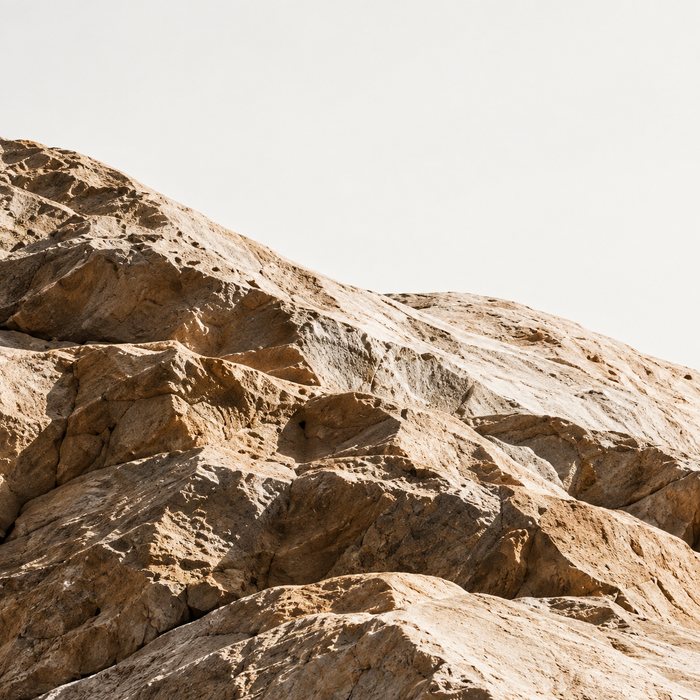 Rugged rock ridge against a pale sky